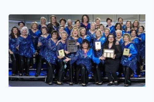 Picture of ladies in the Pacific Empire Chorus all dressed in blue sequin outfits.