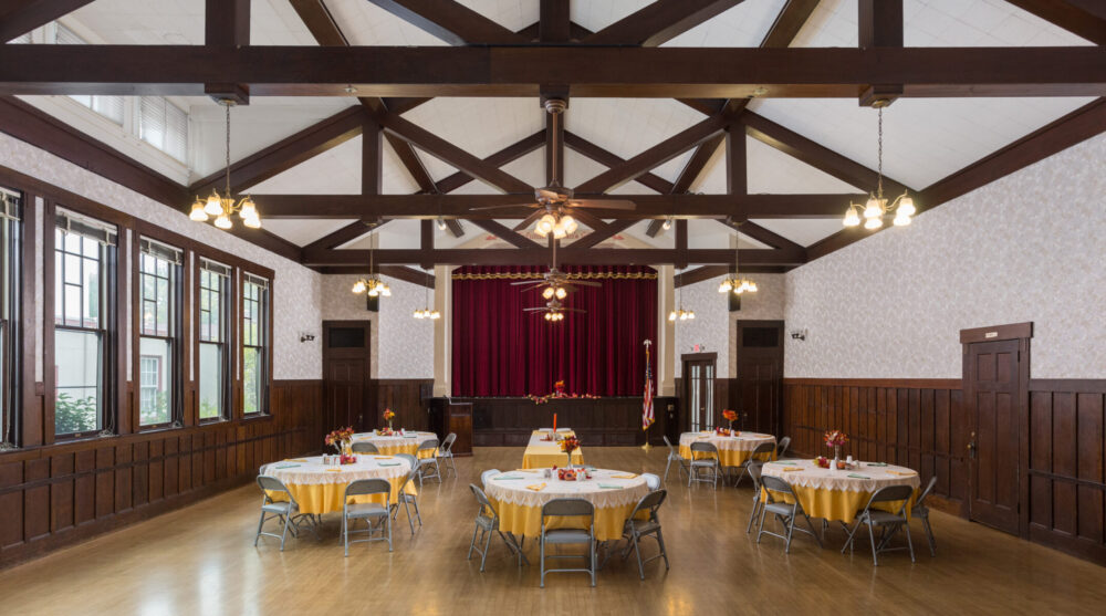 PWC Clubhouse view stage - yellow themed tables